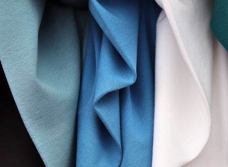 Close up view on colorful hanging and folded fabric textures and textiles in high resolution found...