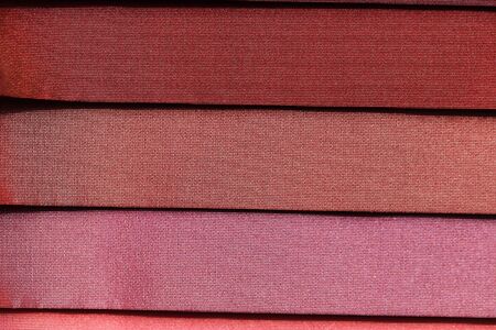 Close up view on colorful hanging and folded fabric textures and textiles in high resolution found...