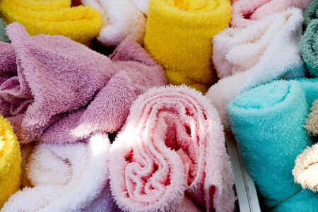 Close up view on colorful hanging and folded fabric textures and textiles in high resolution found on a fabrics marketの写真素材