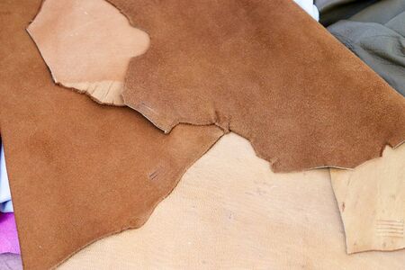 Close up view on colorful hanging and folded fabric textures and textiles in high resolution found on a fabrics marketの写真素材