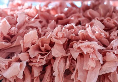 Close up view on colorful hanging and folded fabric textures and textiles in high resolution found on a fabrics marketの写真素材