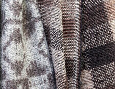 Close up view on colorful hanging and folded fabric textures and textiles in high resolution found...