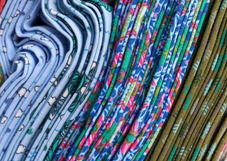 Close up view on colorful hanging and folded fabric textures and textiles in high resolution found...