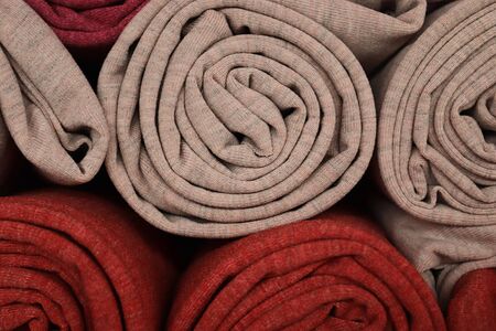 Close up view on colorful hanging and folded fabric textures and textiles in high resolution found on a fabrics marketの写真素材