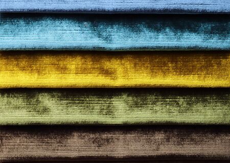 Close up view on colorful hanging and folded fabric textures and textiles in high resolution found on a fabrics marketの写真素材