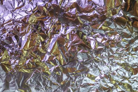 Detailed close up texture of an aluminum foil surface in different colorsの写真素材
