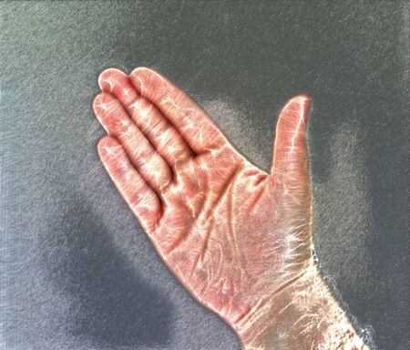 Photo of a glowing human male hand with a kirlian aura showing different symbolsの写真素材