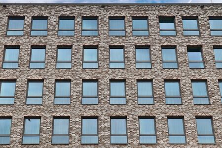 Modern office building facades with glass and reflecting sunlight in the windows found in kiel in germanyの写真素材