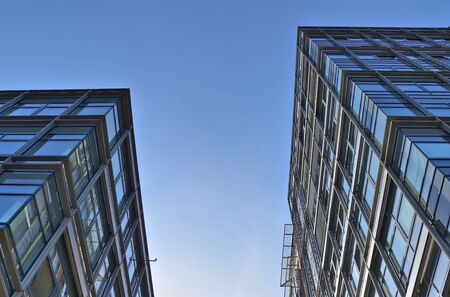 Modern office building facades with glass and reflecting sunlight in the windows found in kiel in...