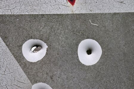Detailed close up view on bullet holes of gunshots at a traffic signの写真素材