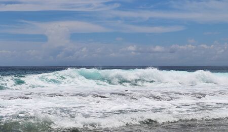 Beautiful splashing turquoise ocean waves at the white beaches on the paradise island Seychelles