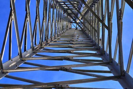 Close up view on a big power pylon transporting electricity in a countryside area
