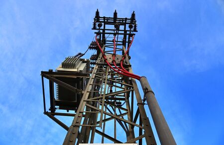 Close up view on a big power pylon transporting electricity in a countryside area