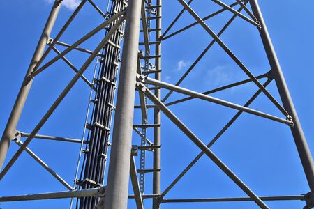 Close up view on a big power pylon transporting electricity in a countryside area