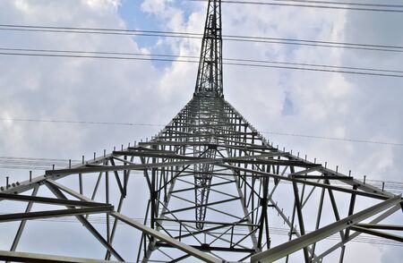 Close up view on a big power pylon transporting electricity in a countryside area