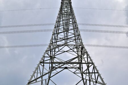 Close up view on a big power pylon transporting electricity in a countryside area