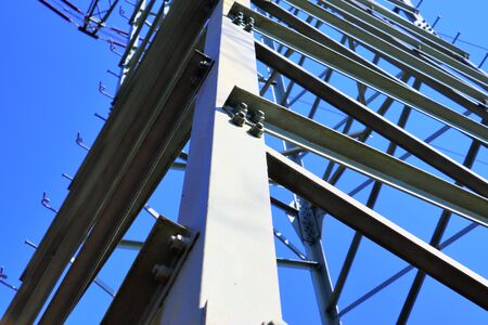 Close up view on a big power pylon transporting electricity in a countryside area