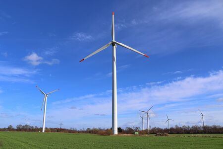 View on alternative energy windmills in a windpark in northern germany in front of a blue sky