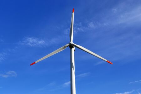 View on alternative energy windmills in a windpark in northern germany in front of a blue sky