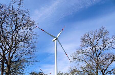View on alternative energy windmills in a windpark in northern germany in front of a blue sky