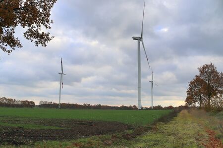 View on alternative energy windmills in a windpark in northern germany in front of a blue sky