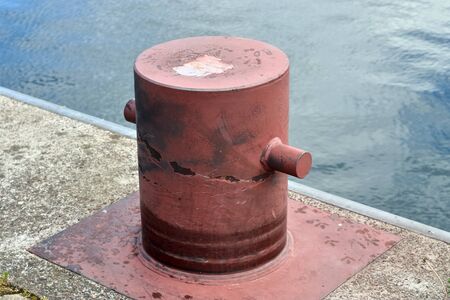 Aged and weathered bollard at the baltic sea port of Kiel in Germanyの写真素材