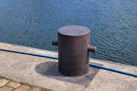 Aged and weathered bollard at the baltic sea port of Kiel in Germany