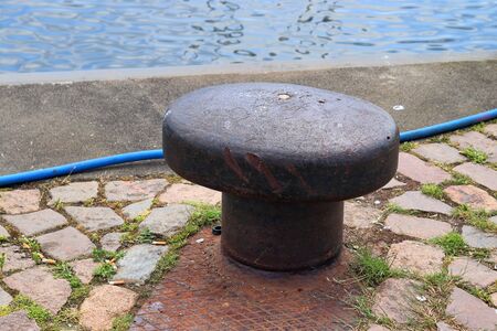 Aged and weathered bollard at the baltic sea port of Kiel in Germanyの写真素材