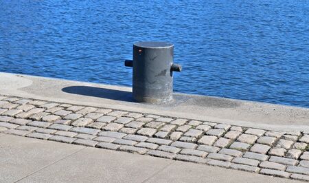 Aged and weathered bollard at the baltic sea port of Kiel in Germanyの写真素材