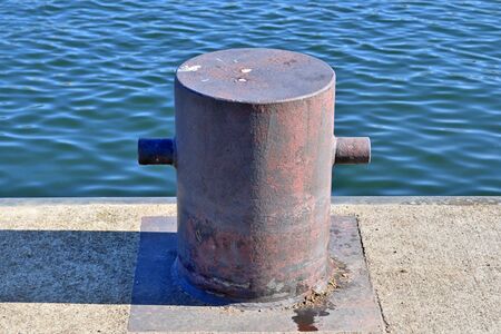 Aged and weathered bollard at the baltic sea port of Kiel in Germany