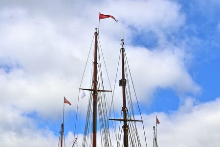 Old sailing shop mast and rope at the port of Kiel on a sunny dayの写真素材