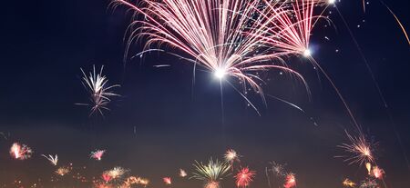 Isolated happy new year fireworks over the roofs of a big city