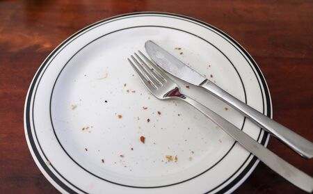 Homemade making of a grilled burger with tomatoes and salad on a plate.の写真素材