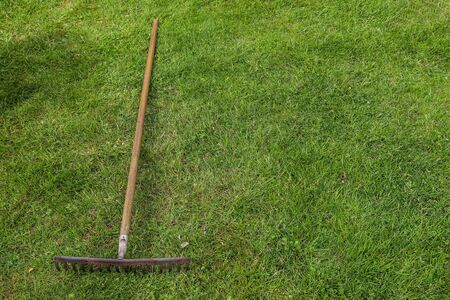 Gardening equipment on grass with empty space.