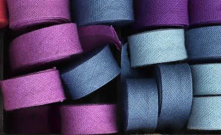 Detailed close up view on samples of cloth and fabrics in different colors found at a fabrics market.の写真素材