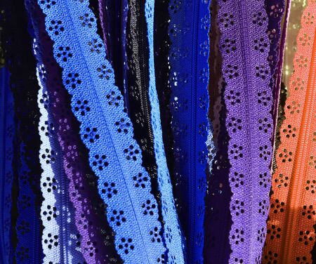 Detailed close up view on samples of cloth and fabrics in different colors found at a fabrics market.の写真素材