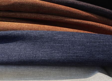 Detailed close up view on samples of cloth and fabrics in different colors found at a fabrics...