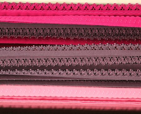 Detailed close up view on samples of cloth and fabrics in different colors found at a fabrics market.の写真素材