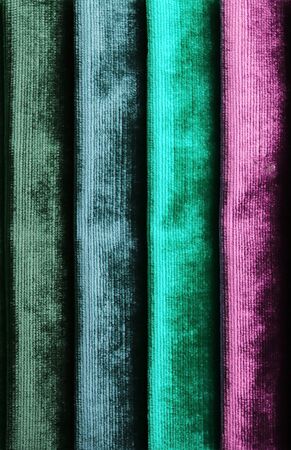Detailed close up view on samples of cloth and fabrics in different colors found at a fabrics market.の写真素材