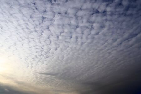 Stunning mixed cloud formation panorama in a deep blue summer sky.