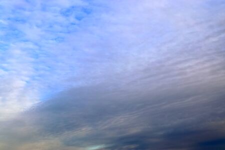 Stunning mixed cloud formation panorama in a deep blue summer sky.の写真素材