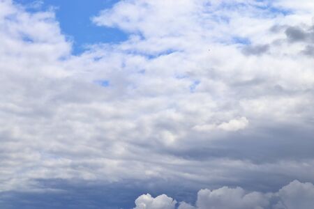 Stunning mixed cloud formation panorama in a deep blue summer sky.