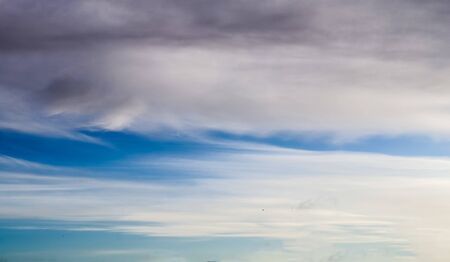 Stunning mixed cloud formation panorama in a deep blue summer sky.の写真素材
