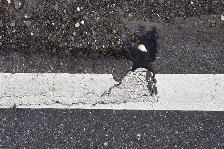 Detailed view on asphalt surfaces of different streets and roads with cracks in a close up