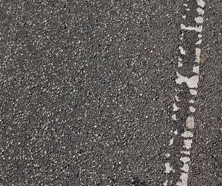 Detailed view on asphalt surfaces of different streets and roads with cracks in a close upの写真素材