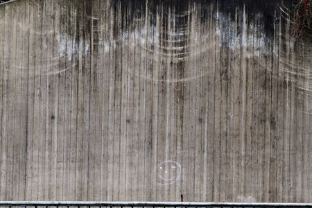 Detailed view on aged concrete walls fronm different modern and hostorical buildings with cracks and...