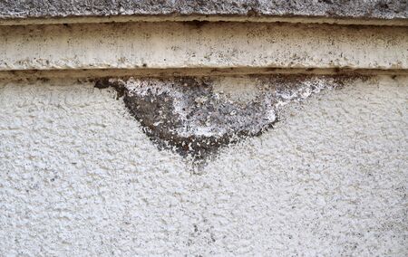 Detailed view on aged concrete walls fronm different modern and hostorical buildings with cracks and...