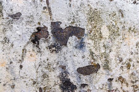 Detailed view on aged concrete walls fronm different modern and hostorical buildings with cracks and...