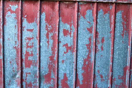 Detailed and colorful close up at cracked and peeling paint on concrete wall textures in high...