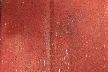 Detailed and colorful close up at cracked and peeling paint on concrete wall textures in high resolution.の写真素材